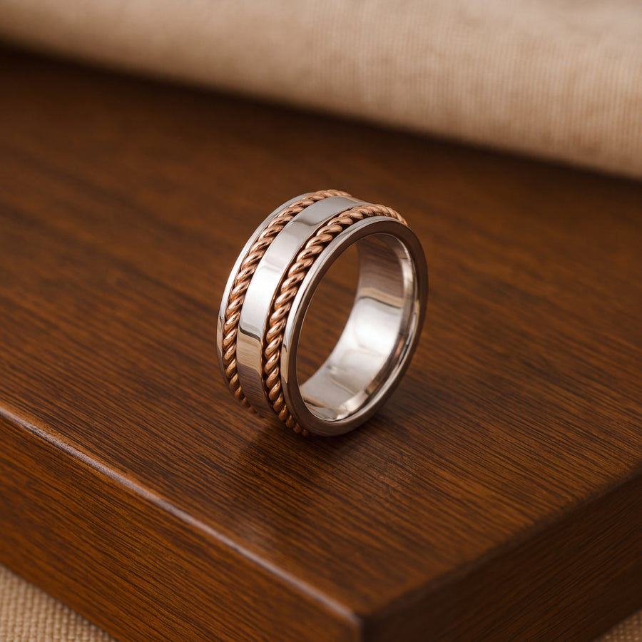 Wide 14K white gold band ring with a polished center framed by two twisted rose gold rope borders