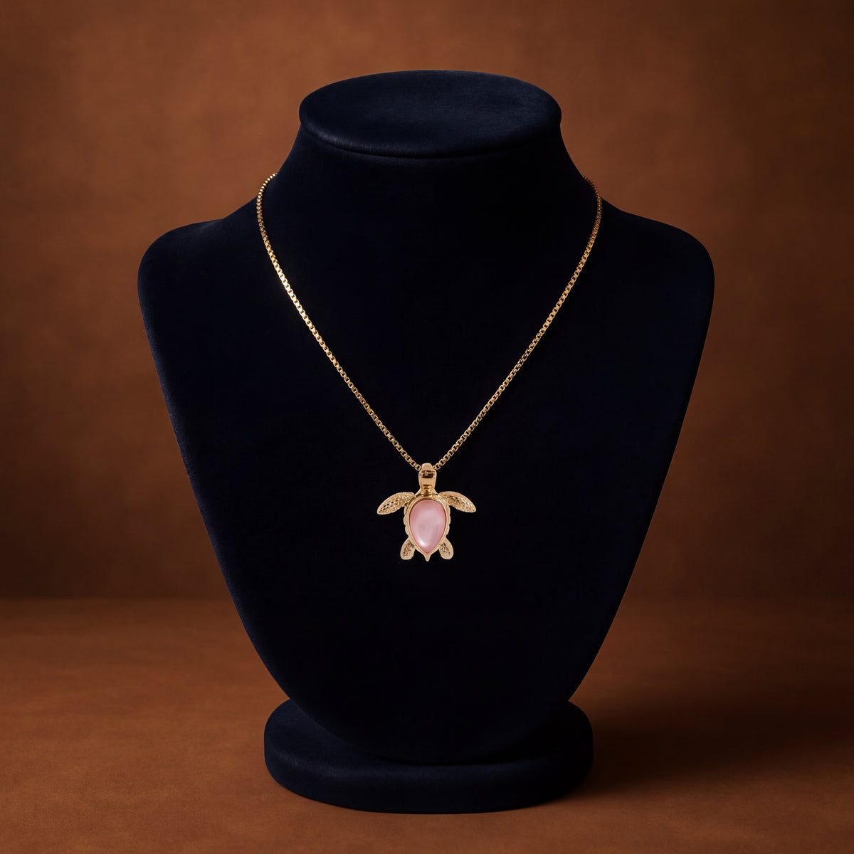 Yellow gold sea turtle charm with a teardrop mother-of-pearl shell and textured flippers on a box chain