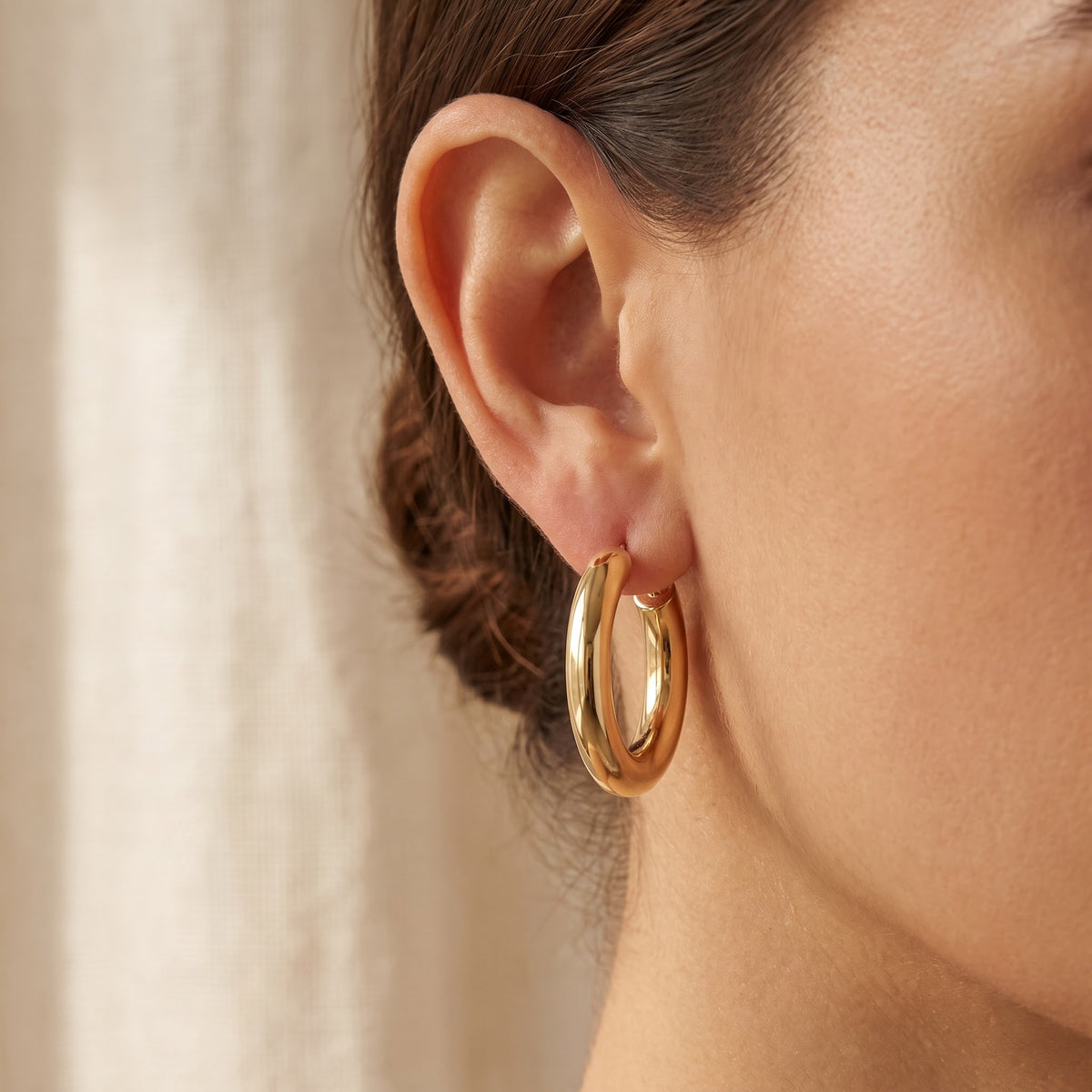 Classic Polished Yellow Gold Hoop Earrings, worn