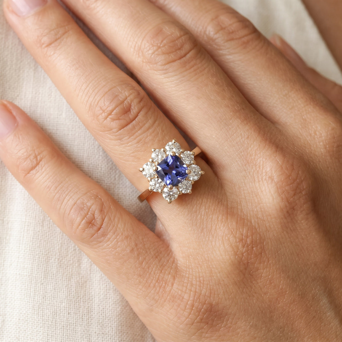 Cushion-Cut Tanzanite Floral Halo Cocktail Ring in Yellow Gold, worn