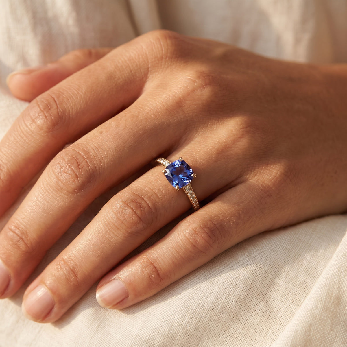 Cushion-Cut Tanzanite Ring with Accent Stones in Yellow Gold, worn