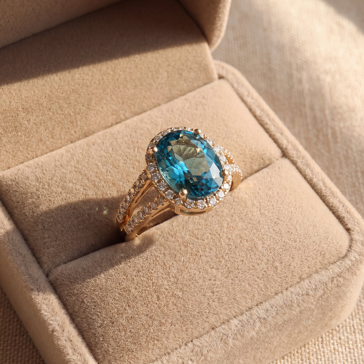 Oval Blue Zircon Split Shank Halo Ring — Yellow Gold