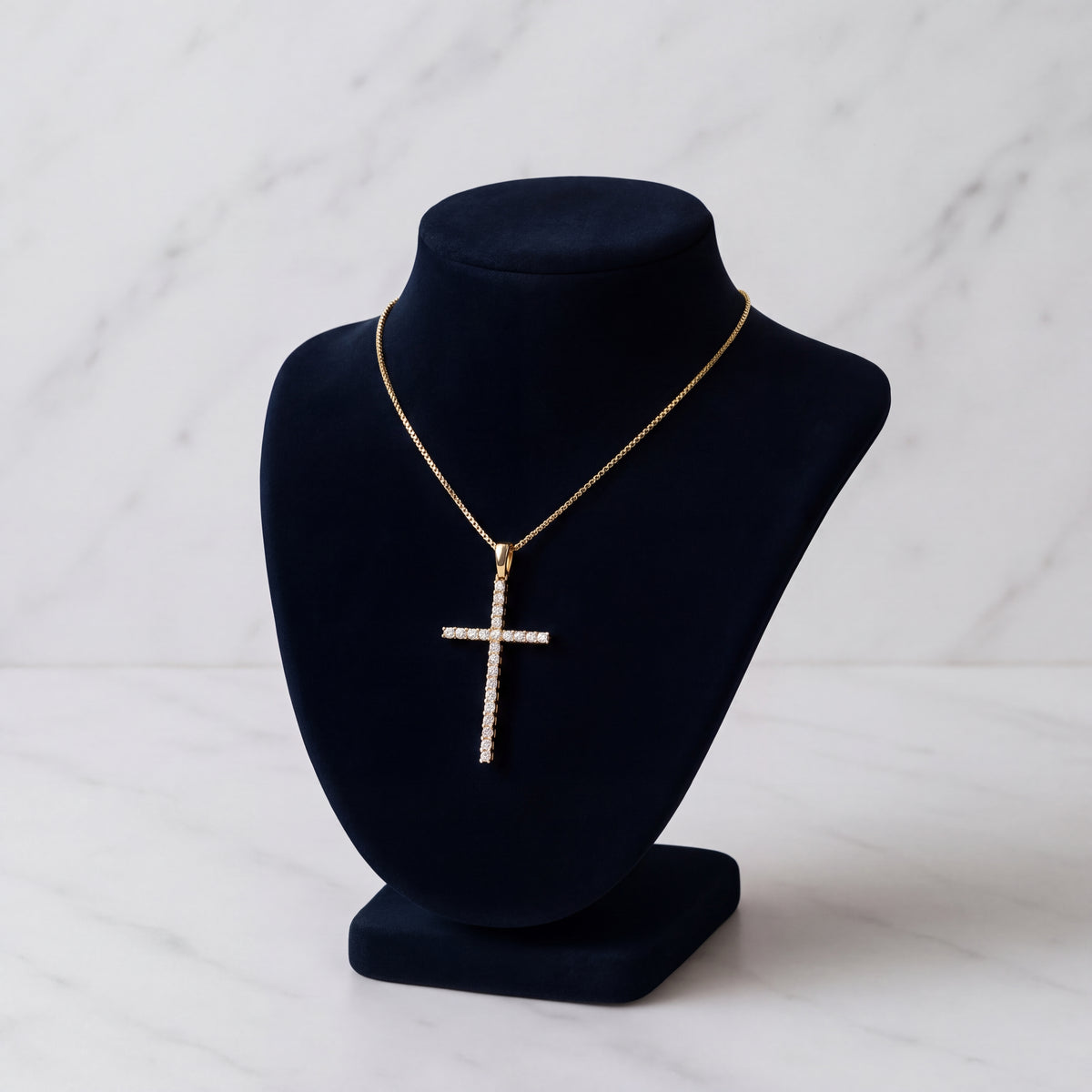 Yellow gold cross traced with a line of diamonds on a chain