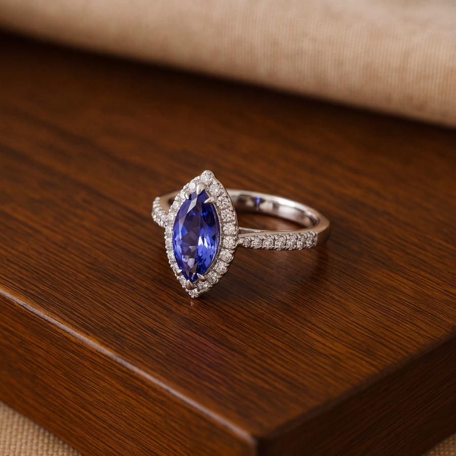 Marquise tanzanite cocktail ring with a diamond halo and diamond-lined band in 14K white gold