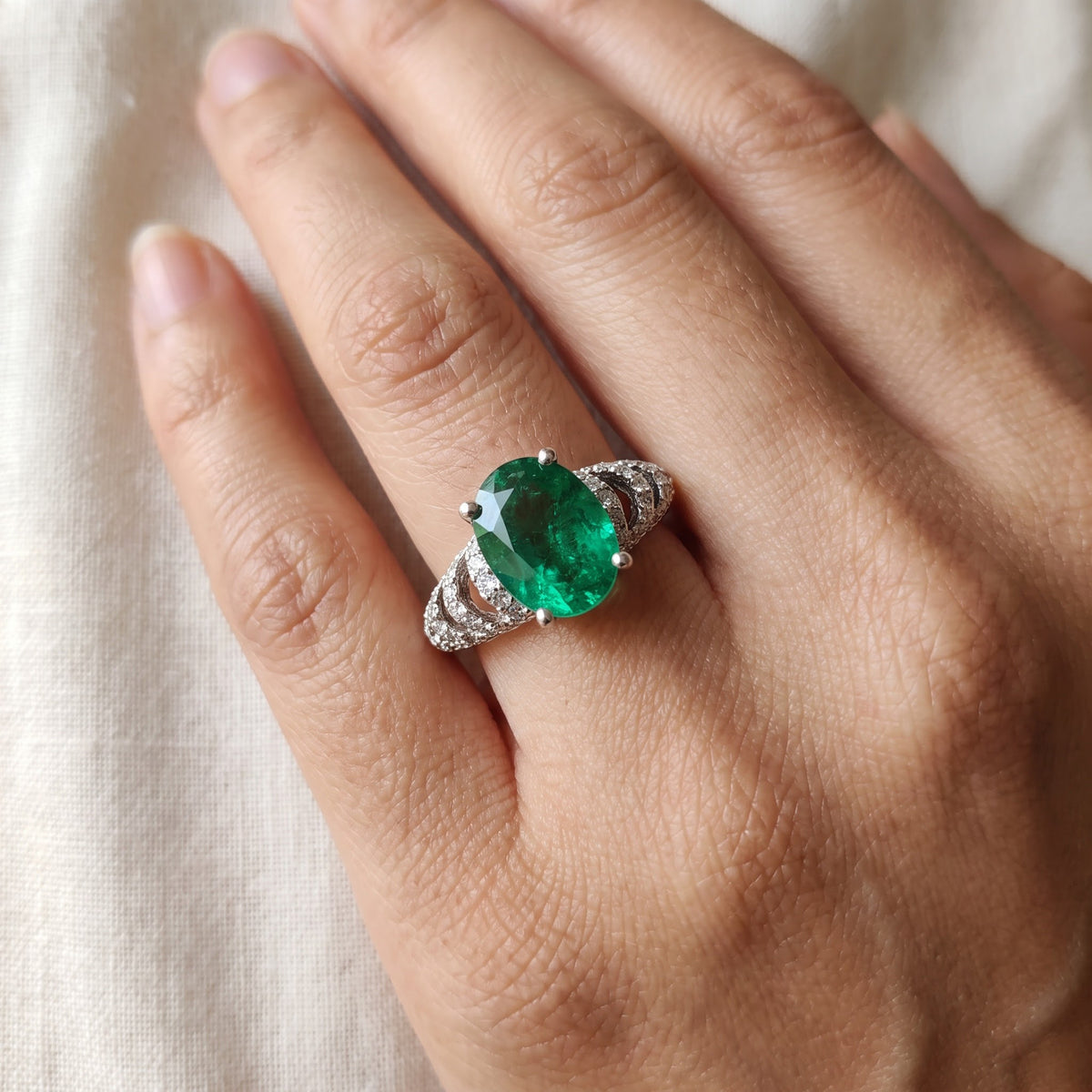 Diamond-Accented Oval Emerald Ring in White Gold, worn