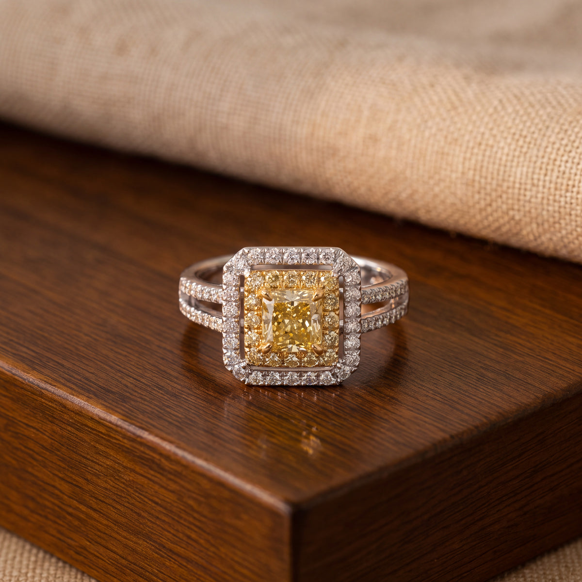 Fancy yellow diamond in a double halo on a diamond split-shank band