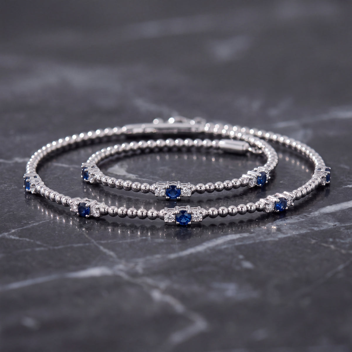 White gold beaded bracelets with blue sapphire stations