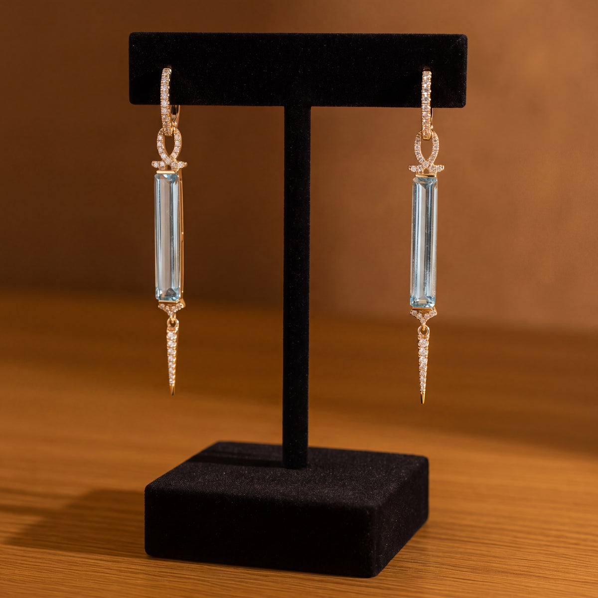 Yellow gold dangle earrings with long rectangular sky blue topaz between pavé diamond hoops and pointed diamond drops