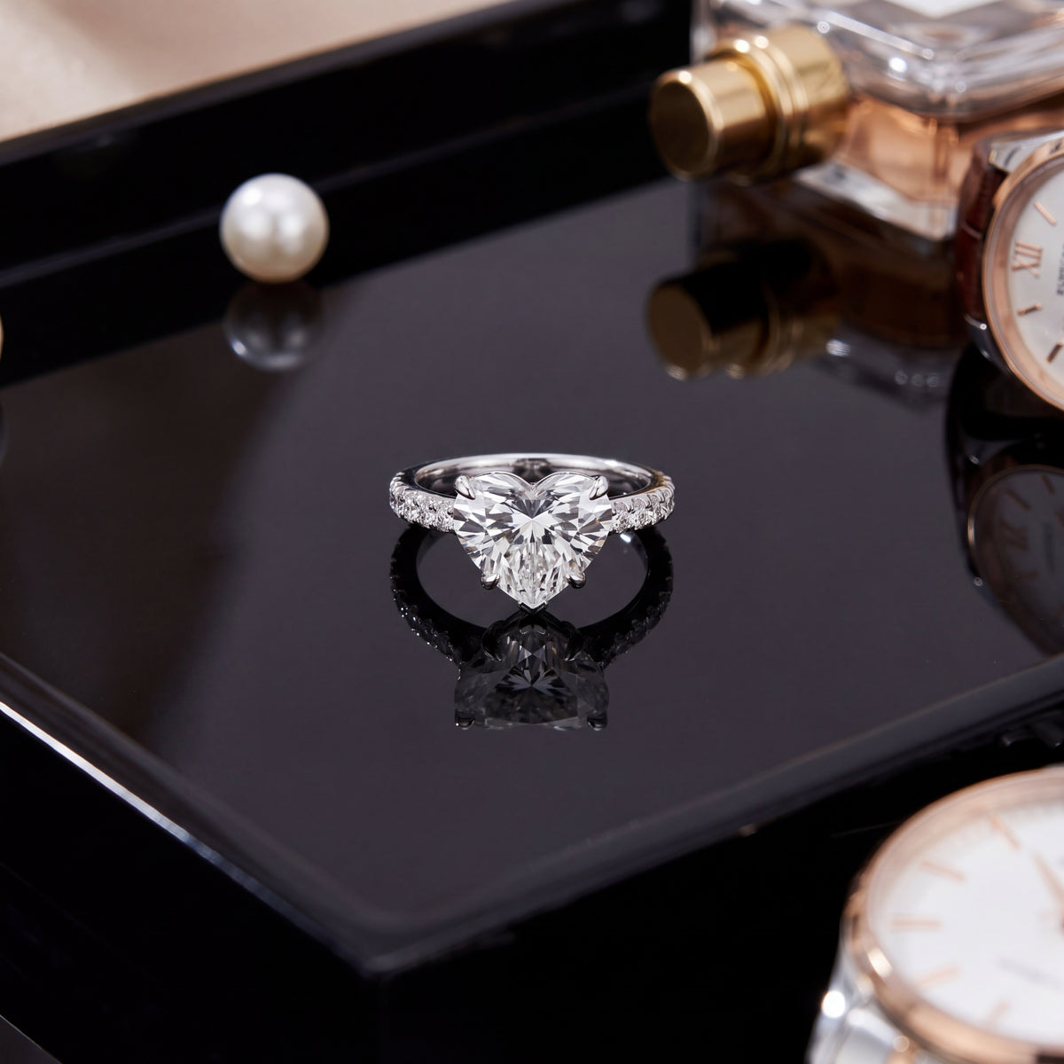 Heart-shaped diamond engagement ring on a band of small diamonds