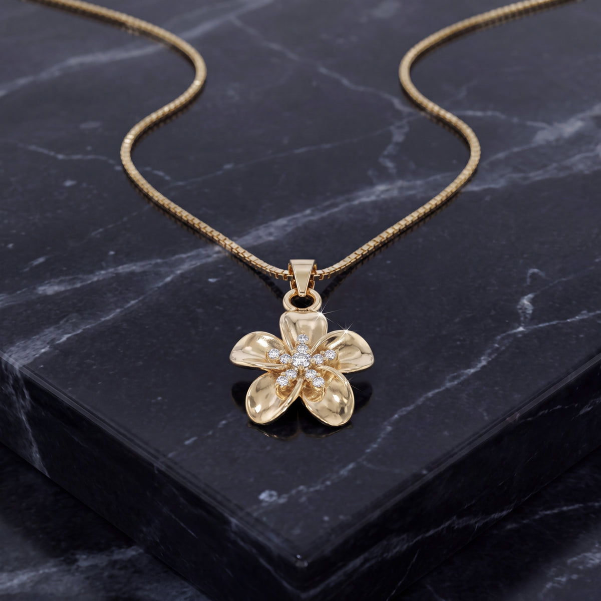 Yellow gold five-petal plumeria charm on a box chain