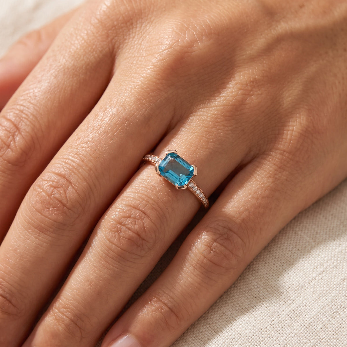East-West Emerald-Cut Blue Topaz Ring in Rose Gold, worn