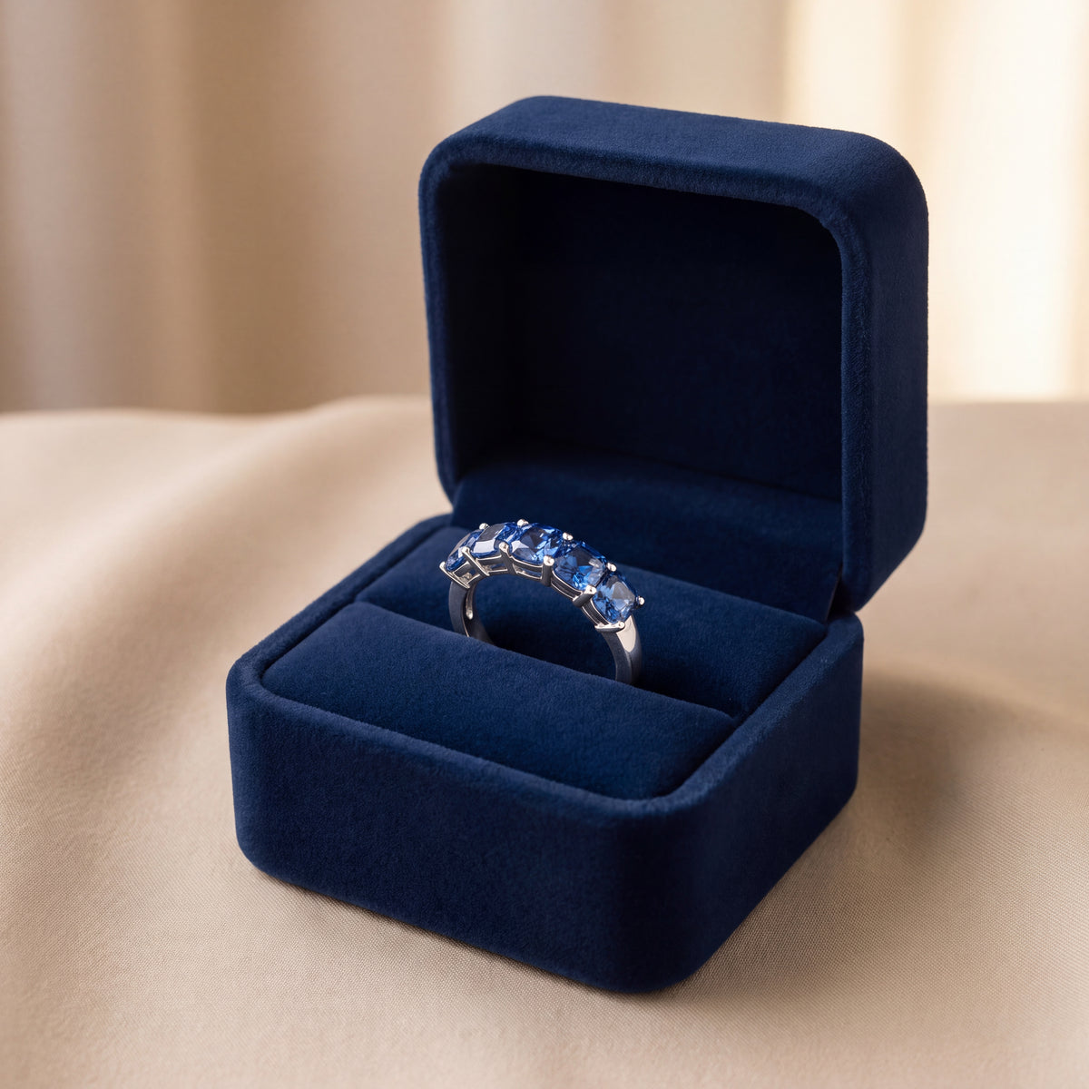 White gold band of five step-cut blue sapphires