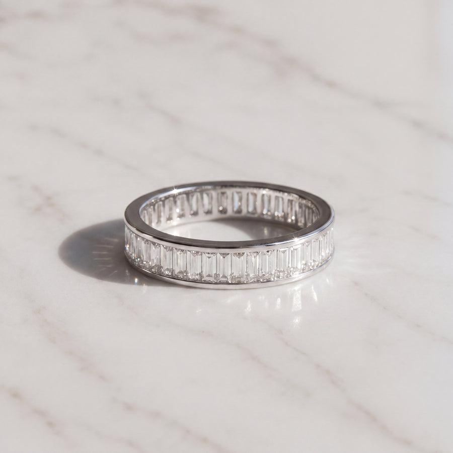 A white gold eternity ring channel-set with baguette diamonds all the way round.