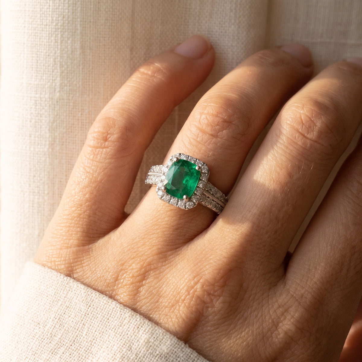 Emerald and Diamond Halo Split Shank White Gold Ring, worn