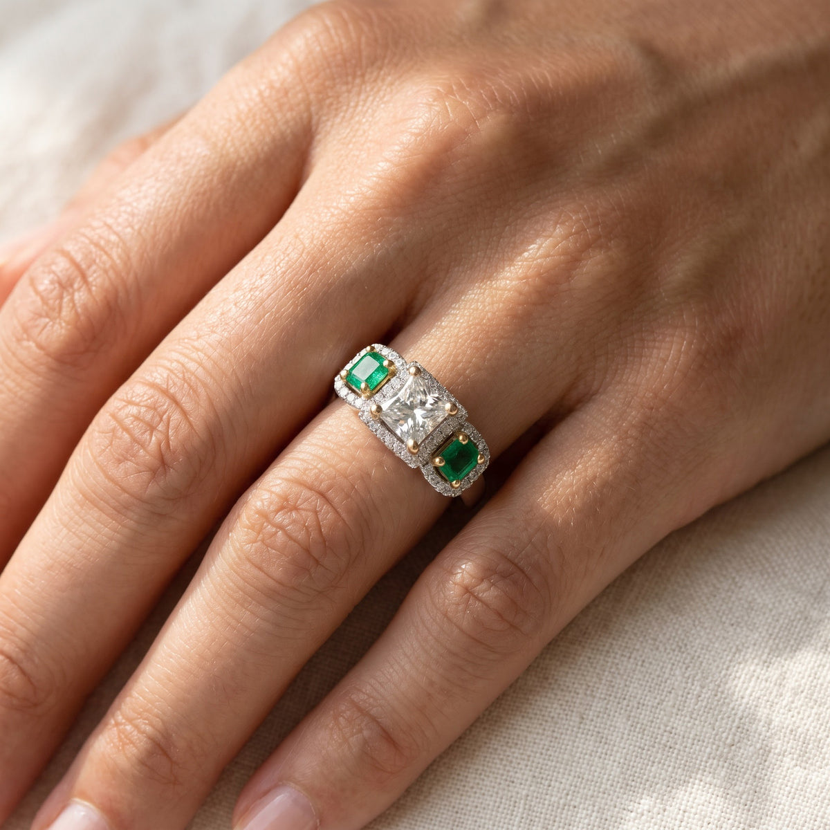 Emerald and Diamond Three-Stone Halo Ring in White Gold, worn