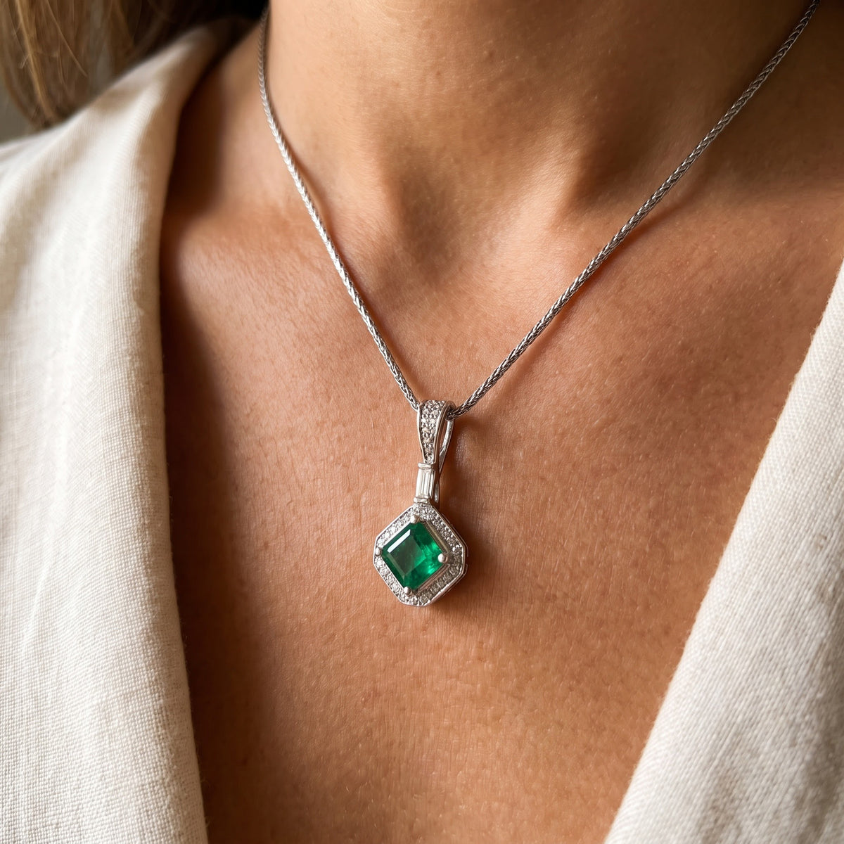 Emerald and White Gold Halo Charm Necklace, worn