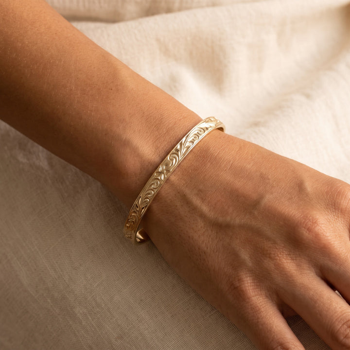 Engraved Floral Bangle Bracelet in 14K Yellow Gold, worn