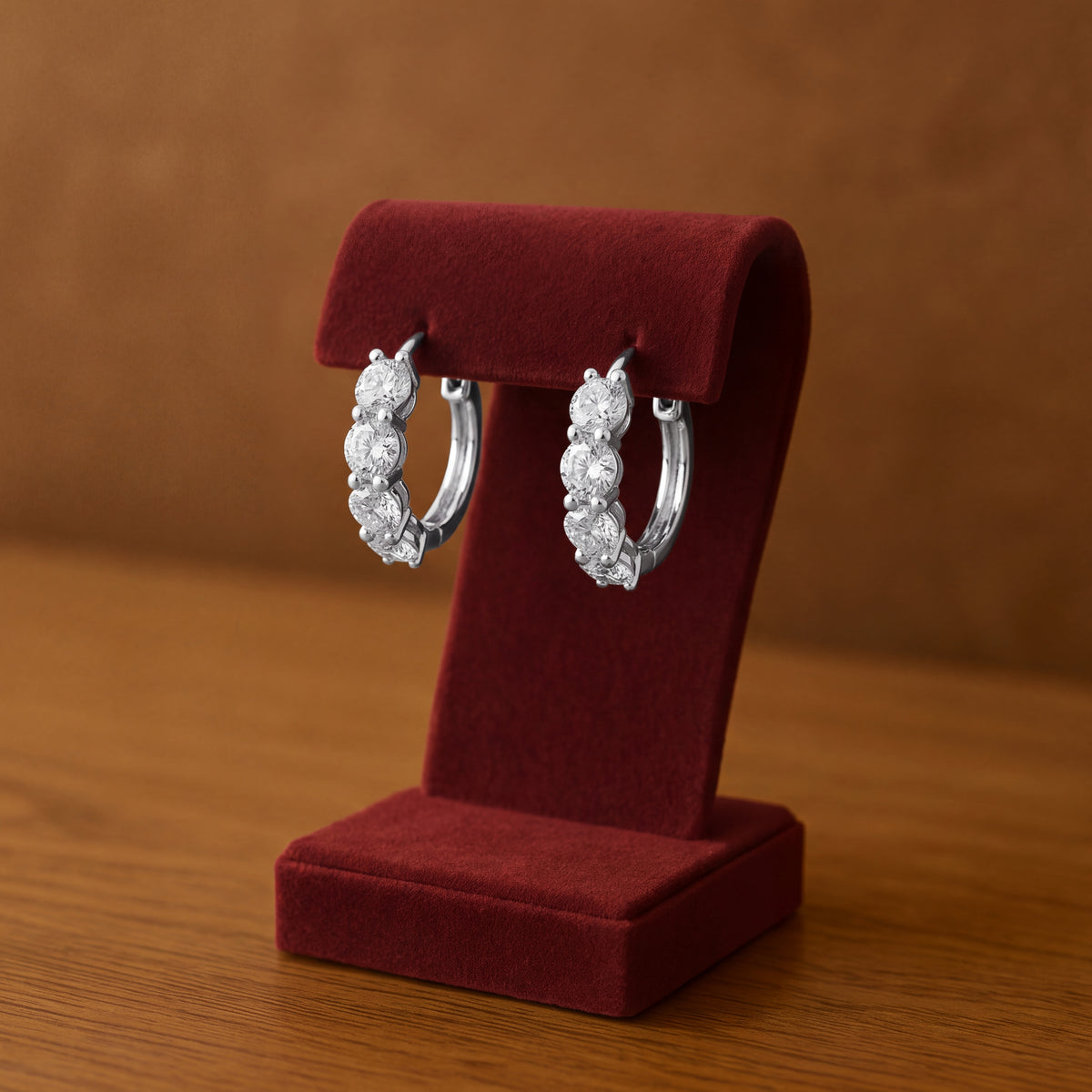 White gold hoop earrings set with a row of round diamonds