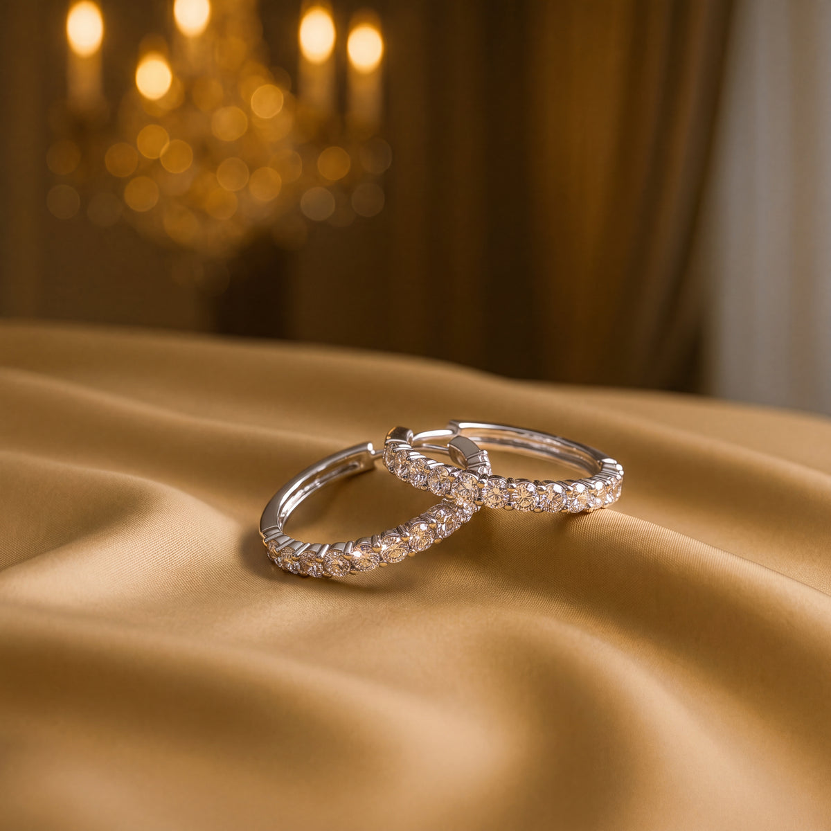 Pair of white gold hoop earrings with diamonds along the front