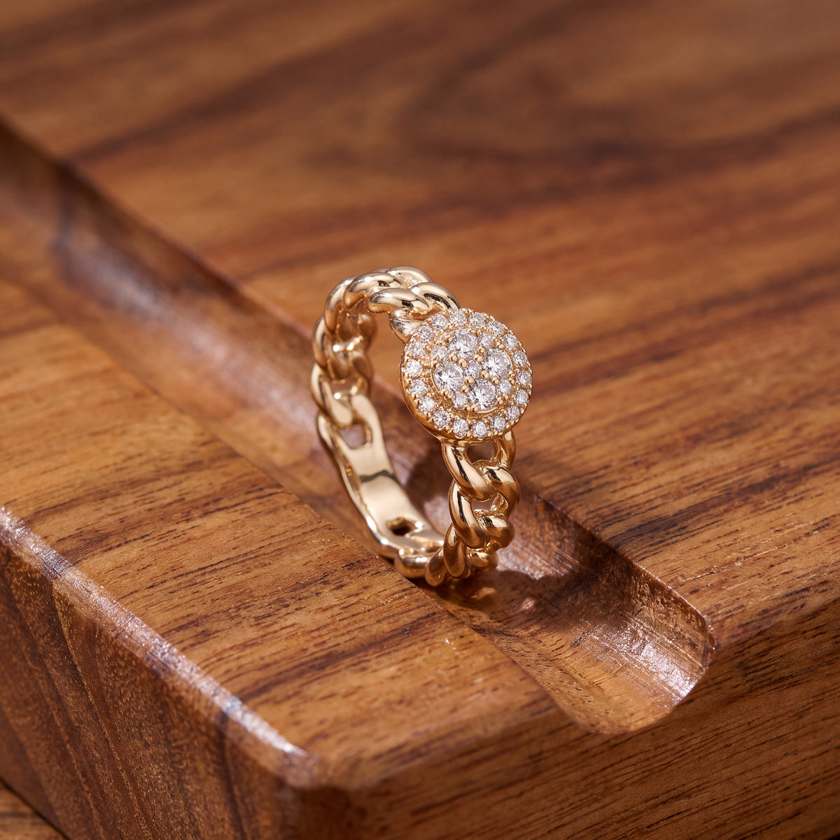 Round diamond cluster on a yellow gold curb chain band