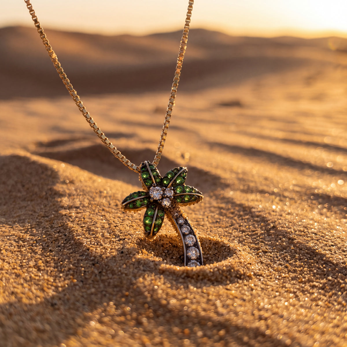 Yellow gold palm tree pendant with green stones in the fronds