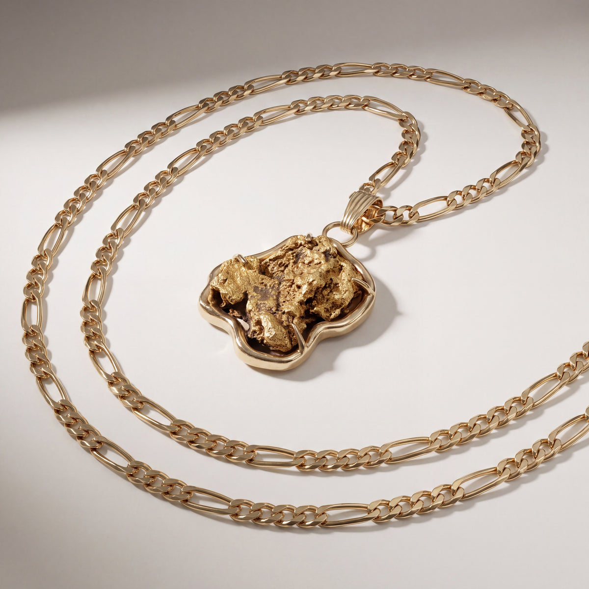 Pendant with a raw gold nugget held in a freeform polished yellow gold bezel