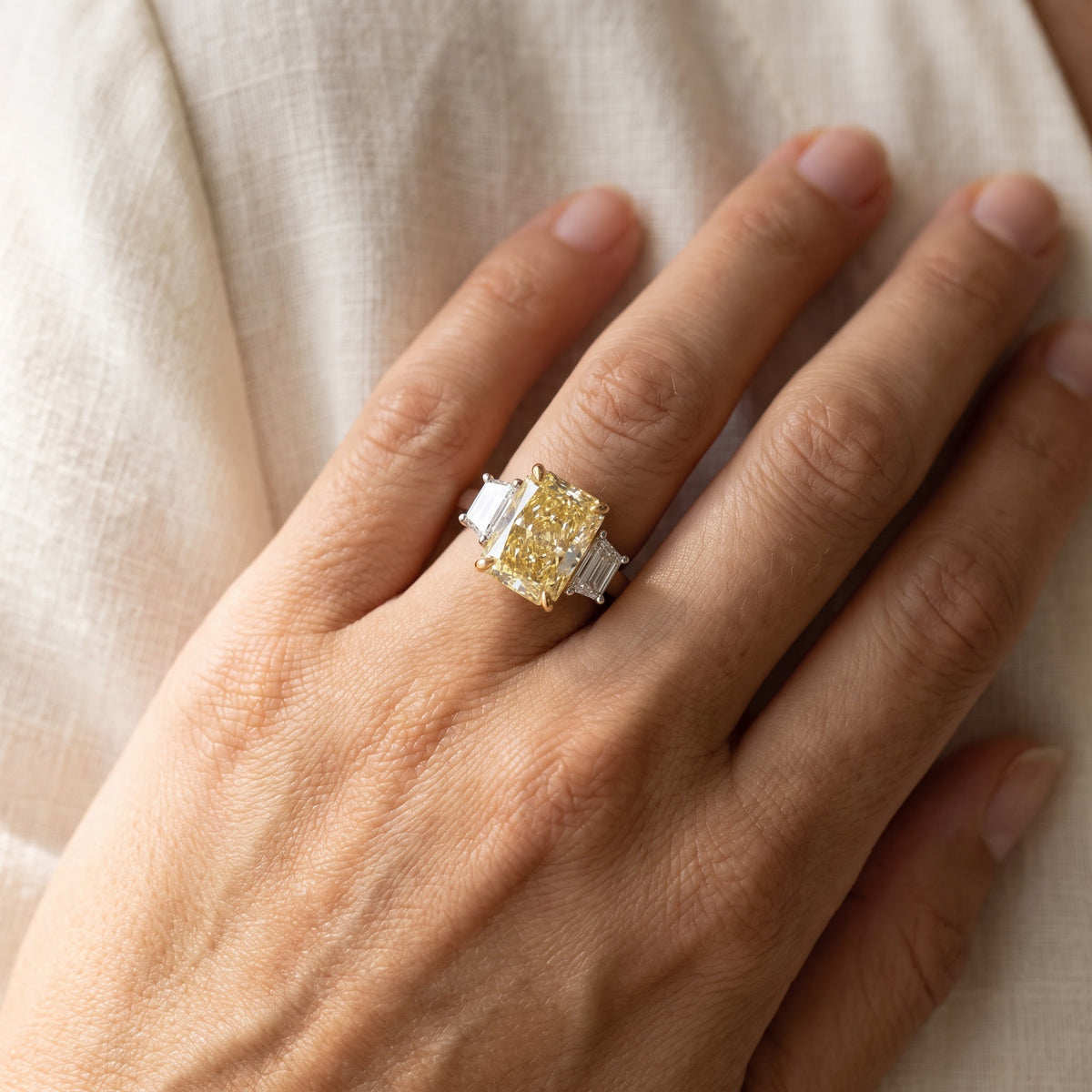 Elongated Radiant Cut Fancy Yellow Diamond Three-Stone Ring in White Gold, worn