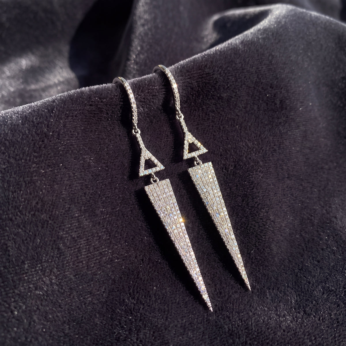 White gold earrings of a triangle above a diamond spike
