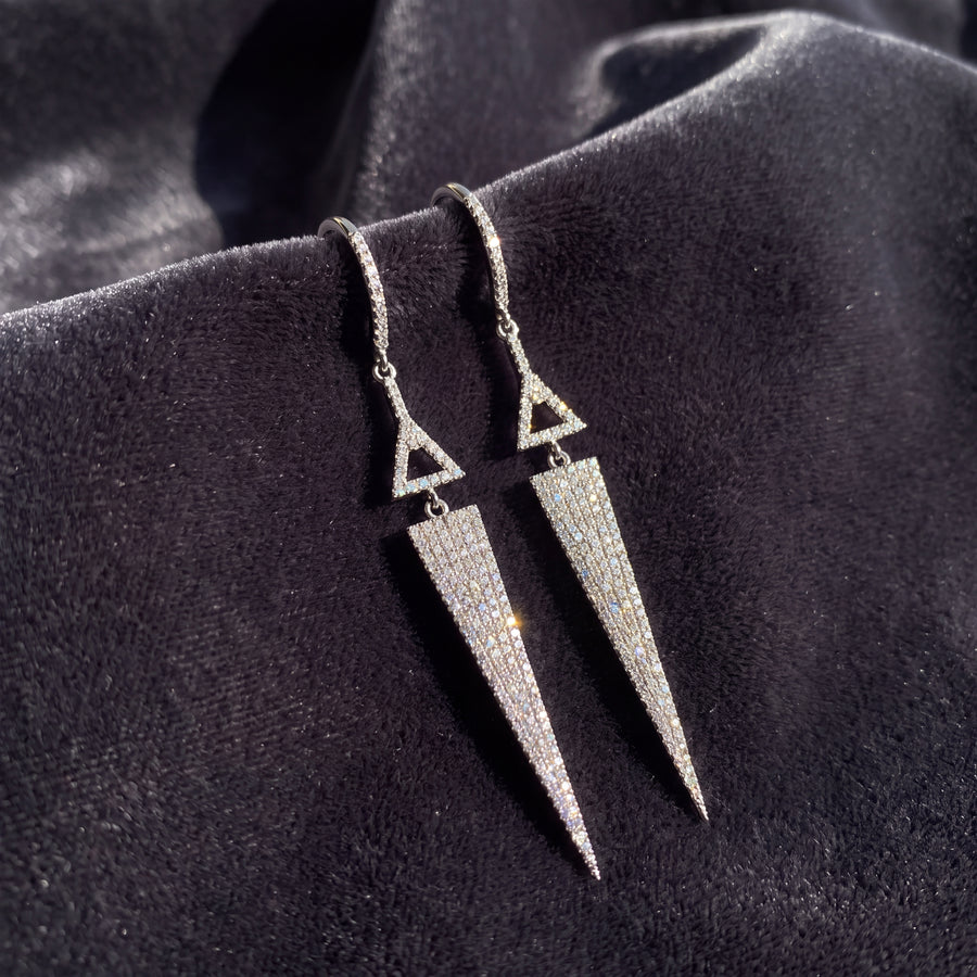 White gold earrings of a triangle above a diamond spike