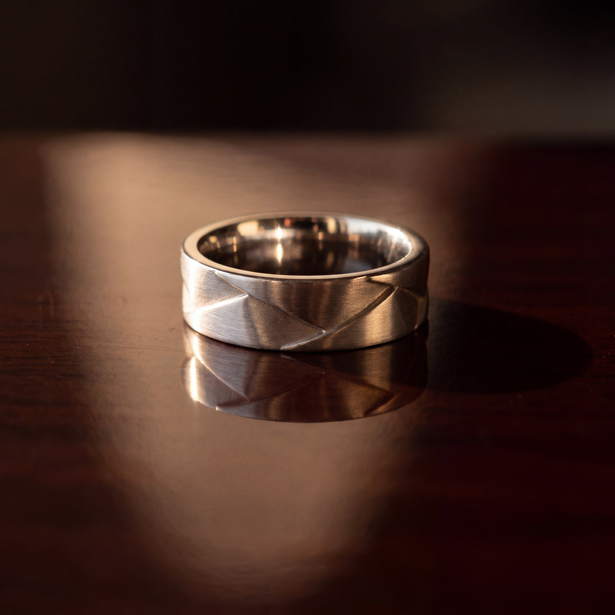 Brushed white gold band with angled geometric facets