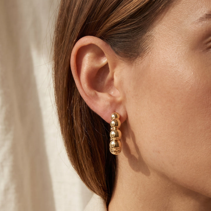 Graduated Bead Hoop Earrings in 14K Yellow Gold, worn