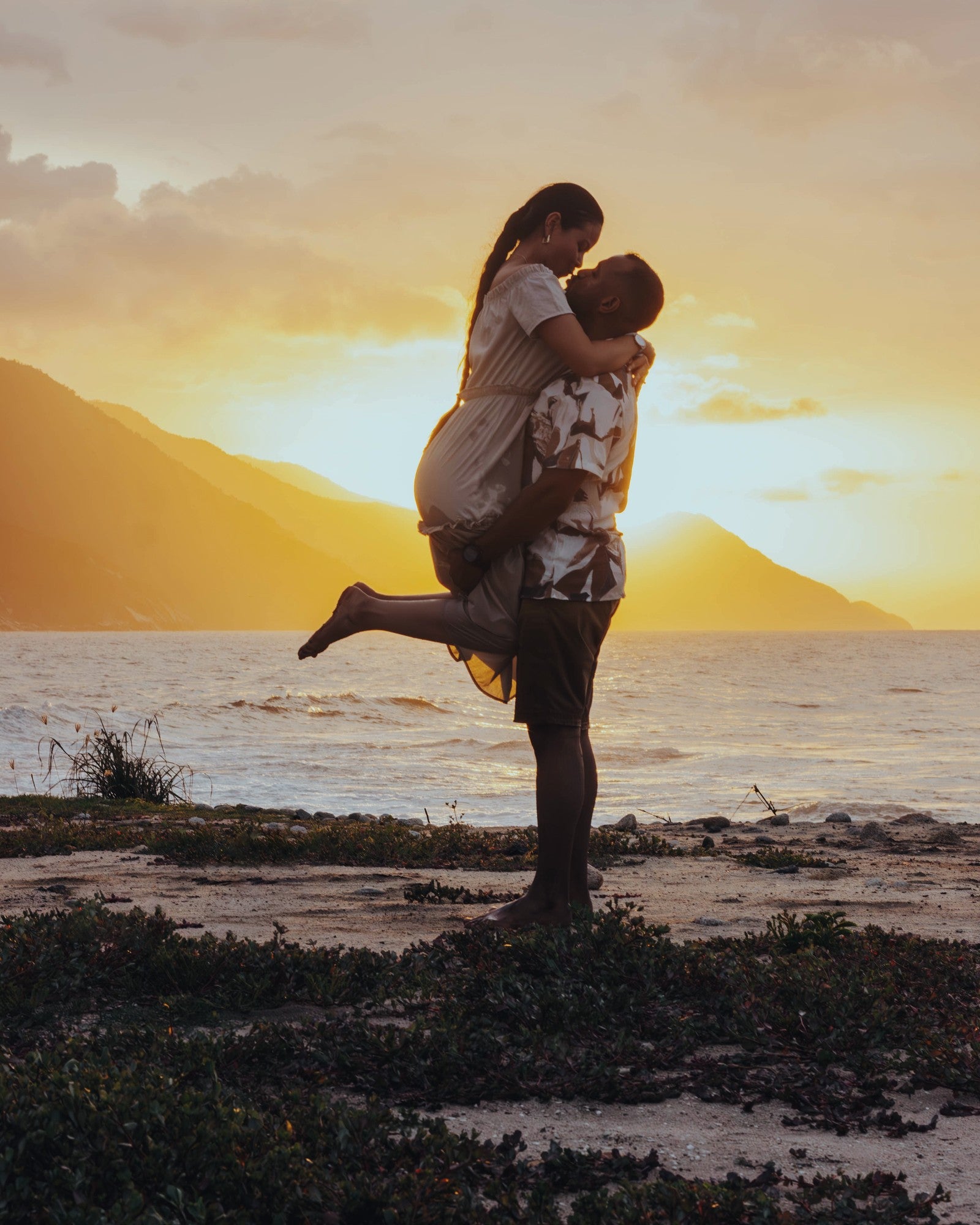A couple at sunset on a Maui shoreline