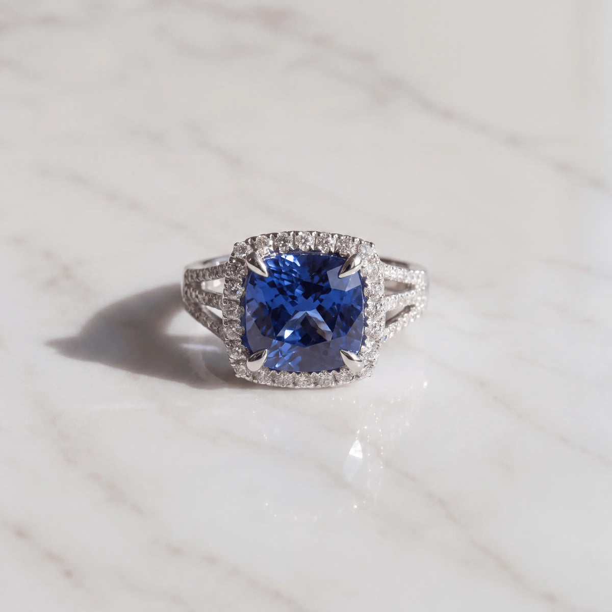 A blue-center halo ring on pale marble
