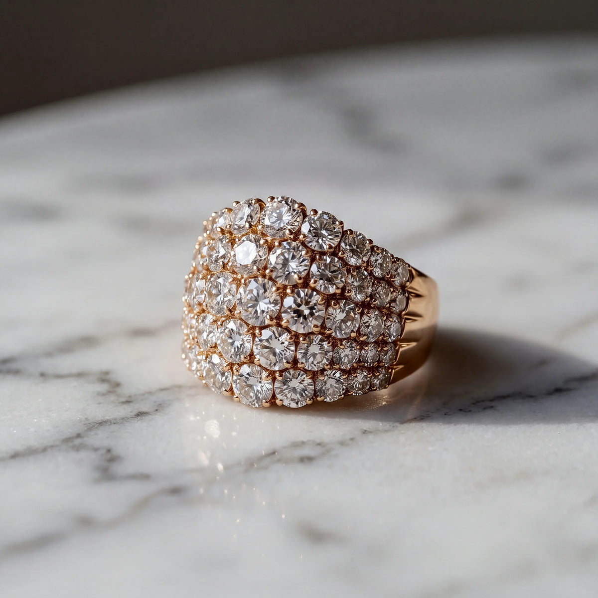 A domed rose gold ring covered in round diamonds