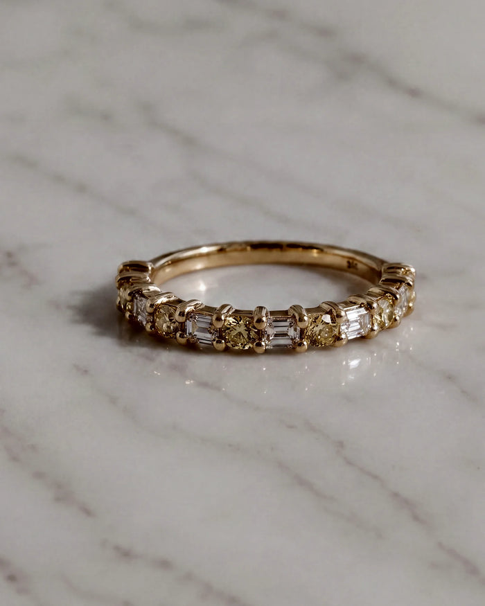 A band of yellow and white diamonds in yellow gold