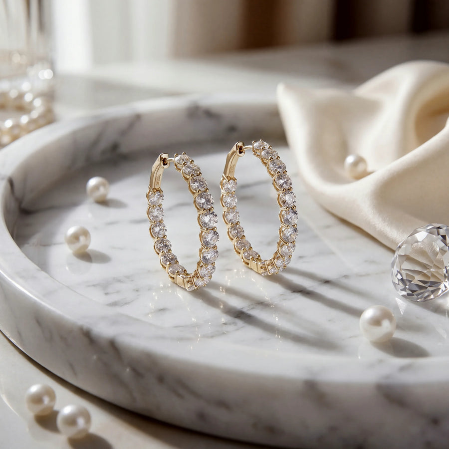 A pair of diamond hoop earrings in yellow gold