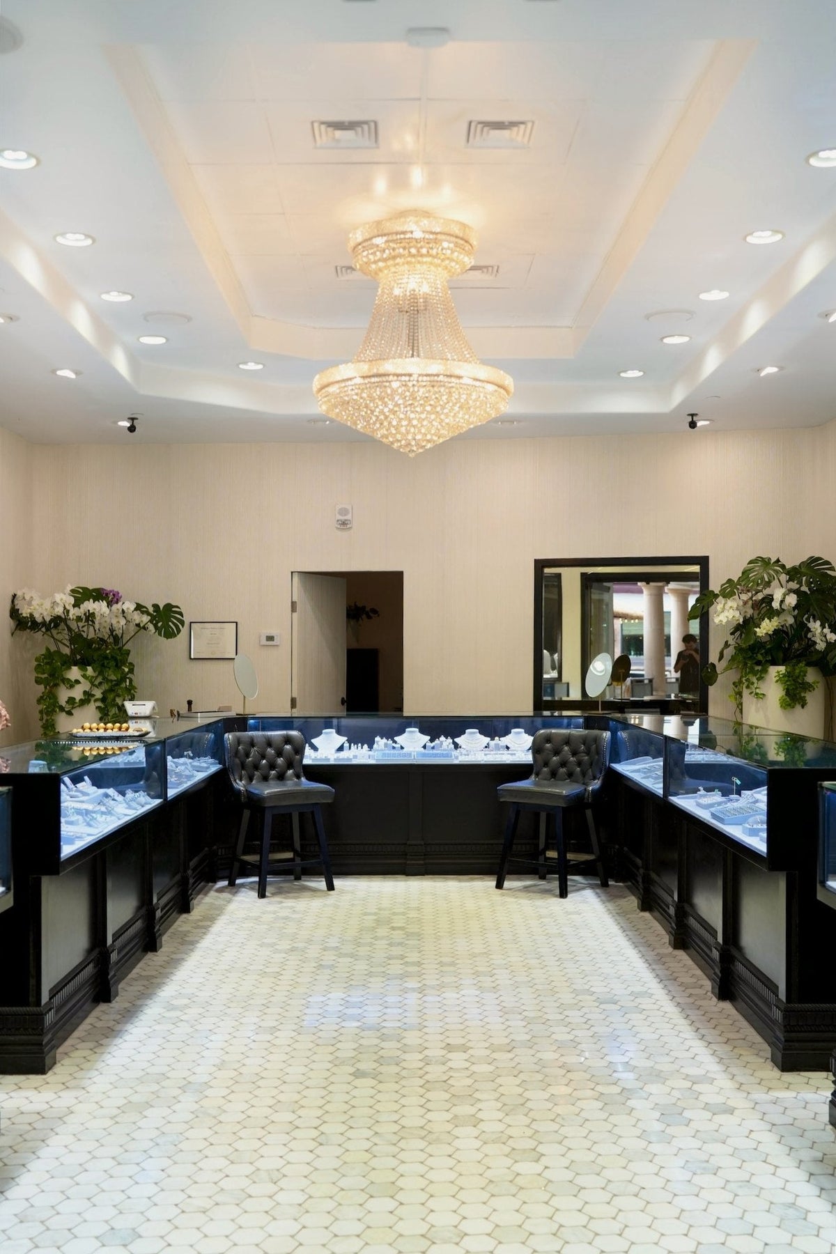 Inside Greenleaf Diamonds: the centre aisle under the chandelier, cases on both sides