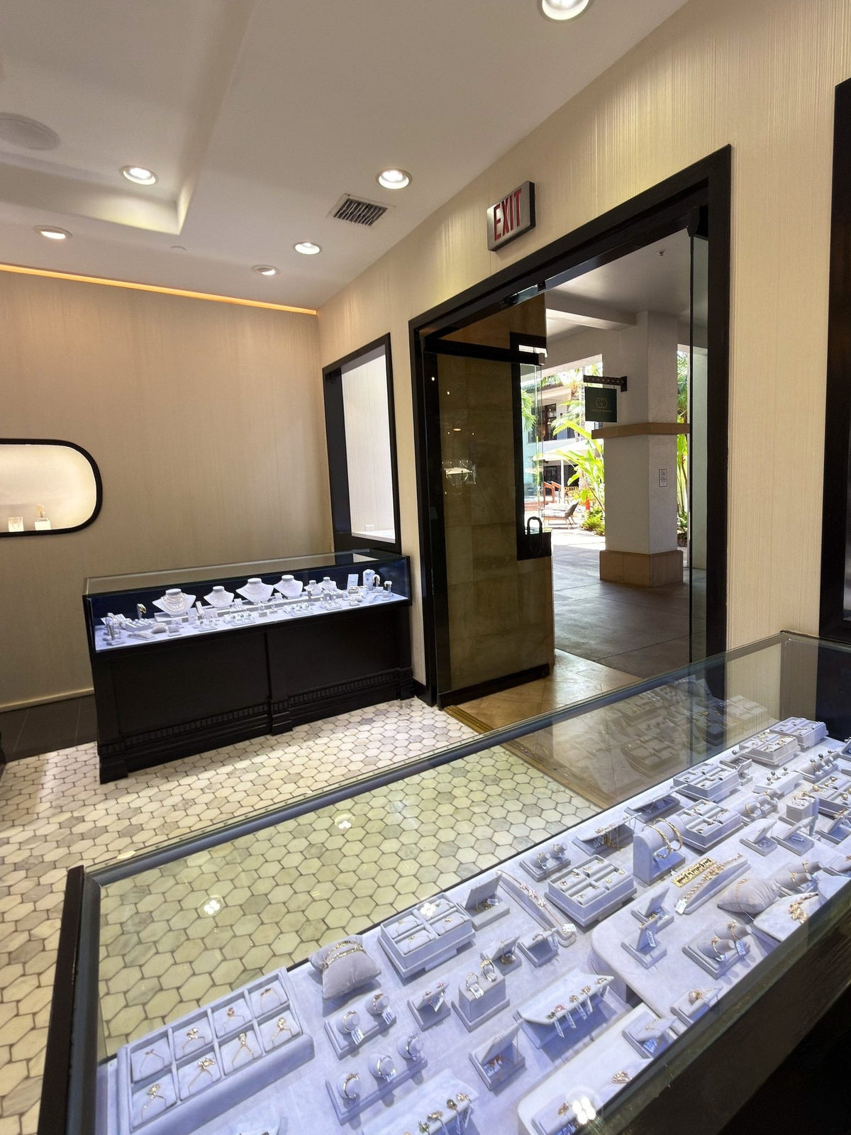 Inside Greenleaf Diamonds: a long case of rings leading to the door