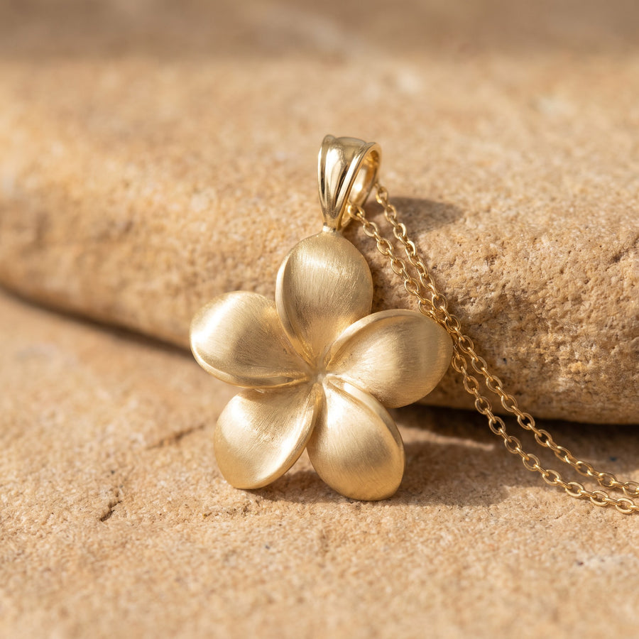 Matte yellow gold plumeria flower pendant on a fine chain
