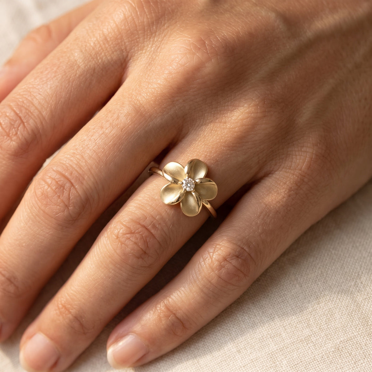 Matte Yellow Gold Plumeria Diamond Solitaire Ring, worn