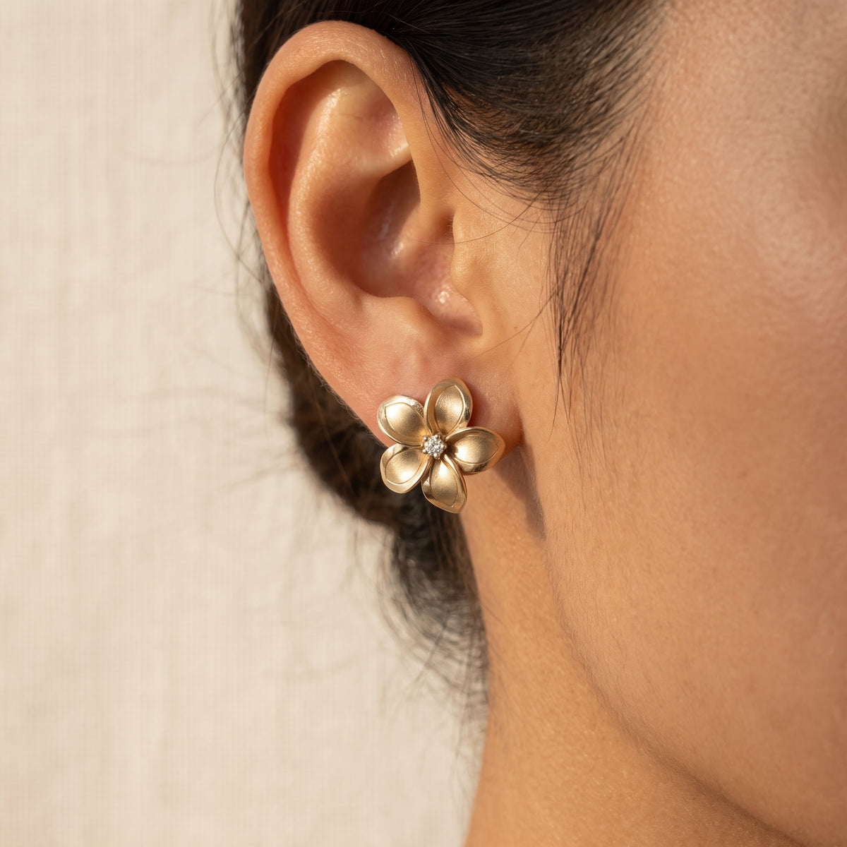 Matte Yellow Gold Plumeria Diamond Stud Earrings, worn