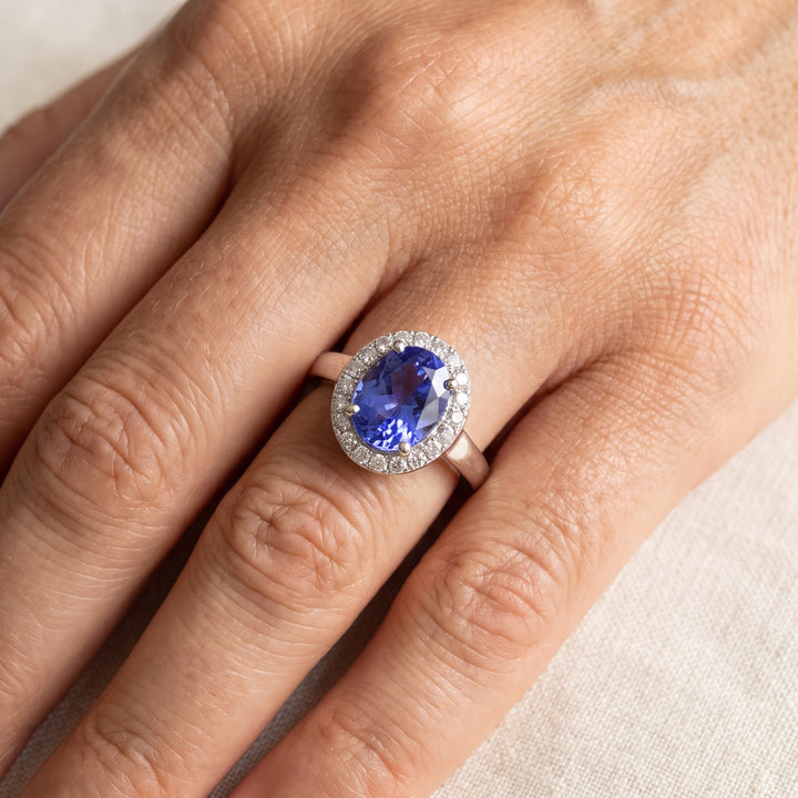 1.03 ct Oval Tanzanite and Diamond Halo Ring with Polished Band in 14K White Gold, worn