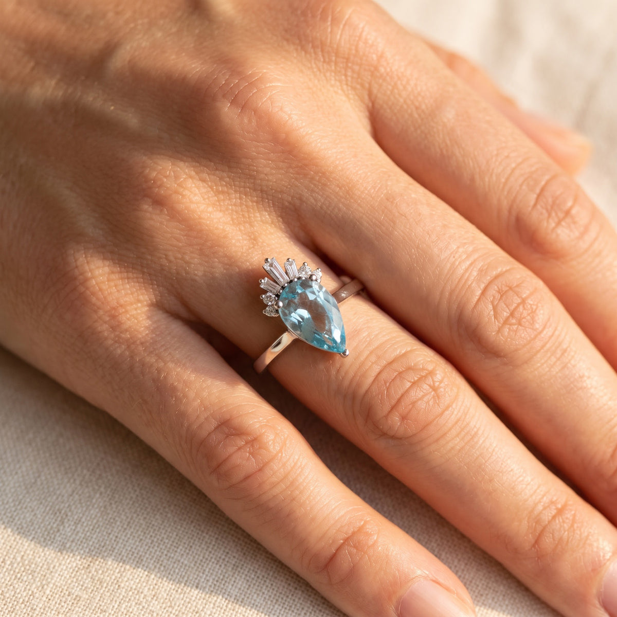 Pear Blue Topaz Crown Cocktail Ring in White Gold, worn