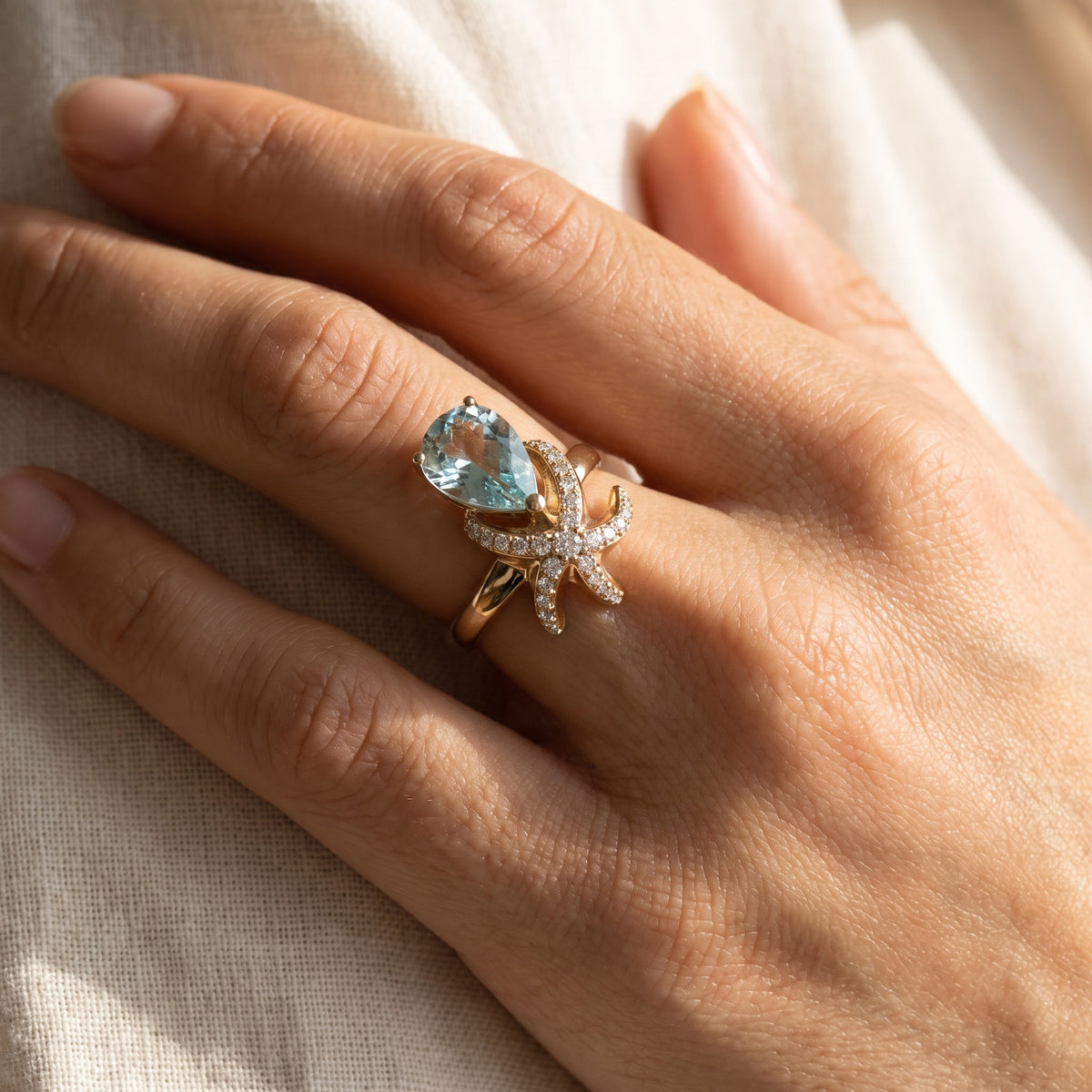 Pear Shape Aquamarine & Diamond Starfish Cocktail Ring in Yellow Gold, worn
