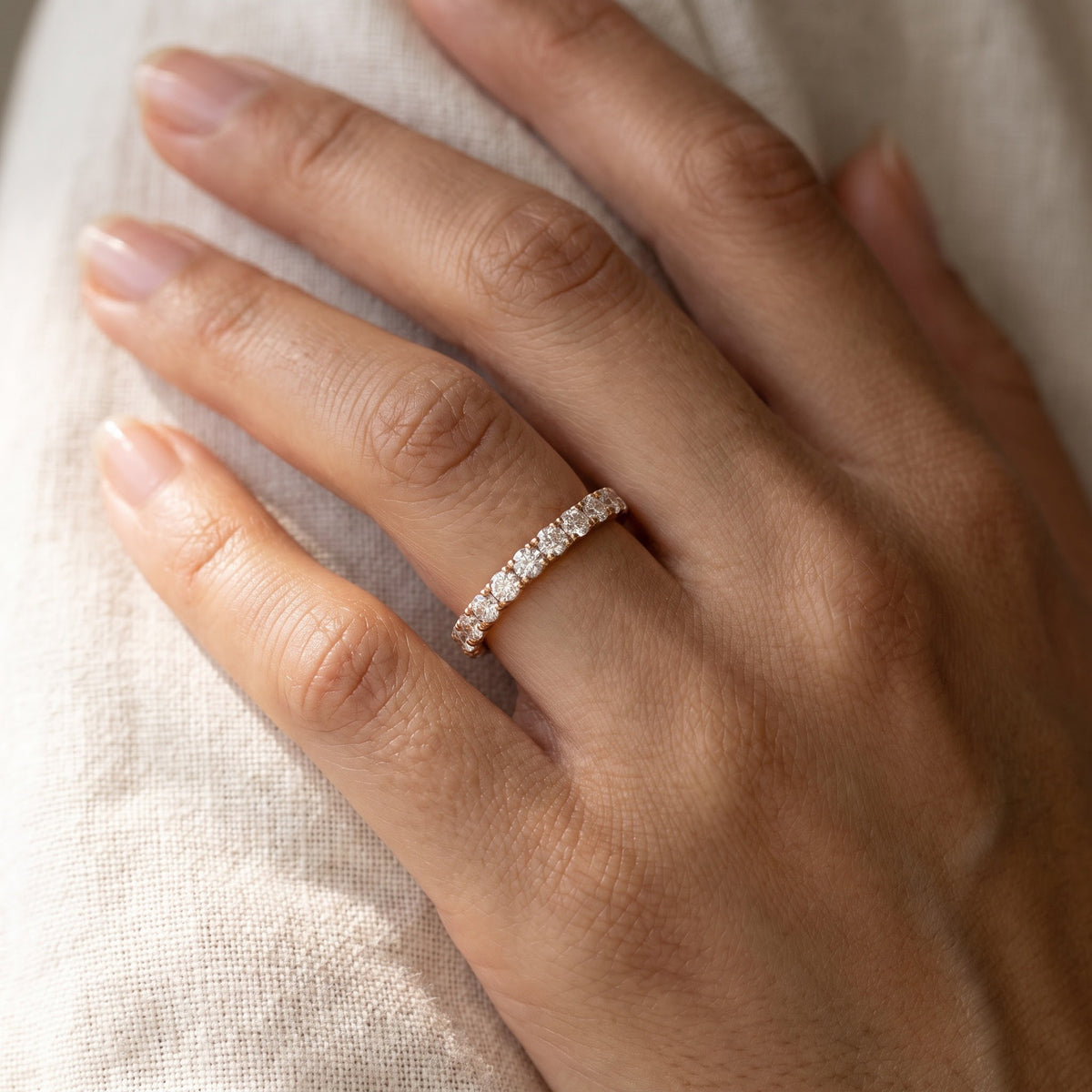 Petite Round Diamond Eternity Ring in Rose Gold, worn