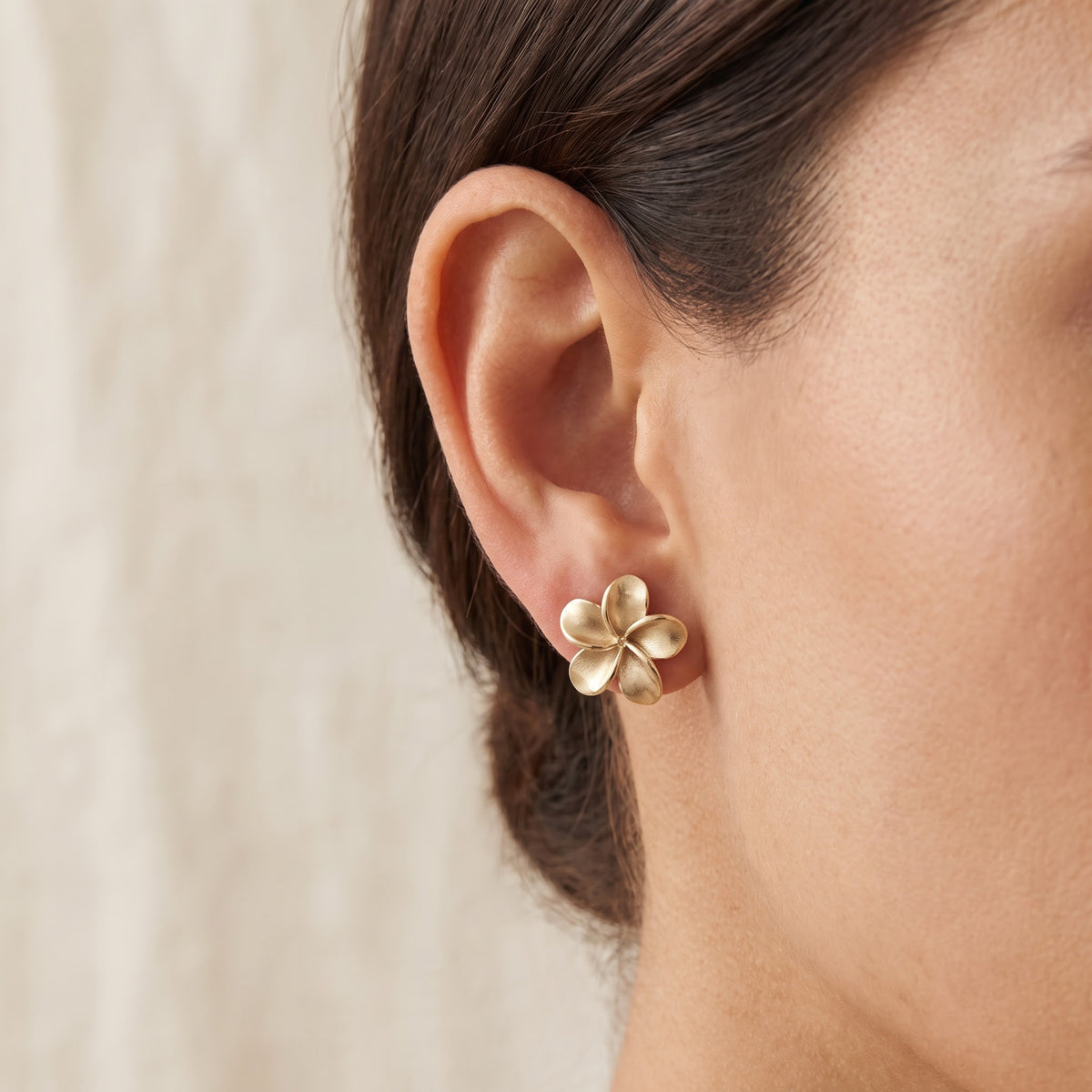 Plumeria Flower Stud Earrings in 14K Yellow Gold, worn