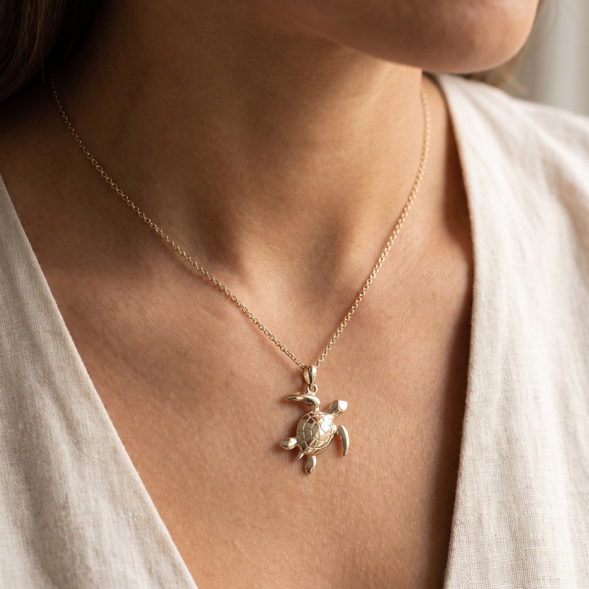 Polished Sea Turtle Pendant Necklace in Yellow Gold, worn
