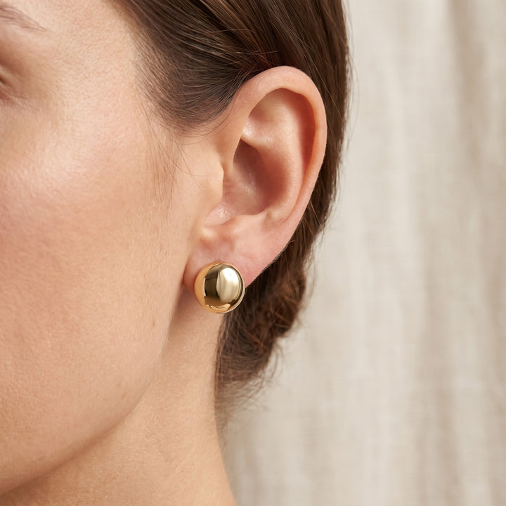 Polished 11mm Dome Stud Earrings in 14K Yellow Gold, worn