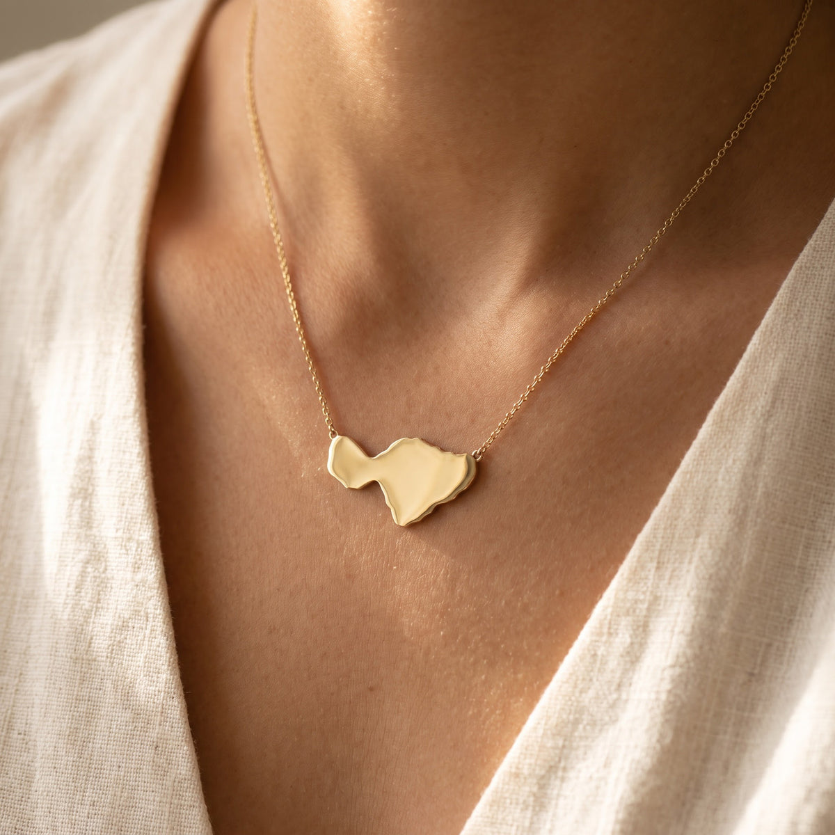 Polished Yellow Gold Island Silhouette Necklace, worn