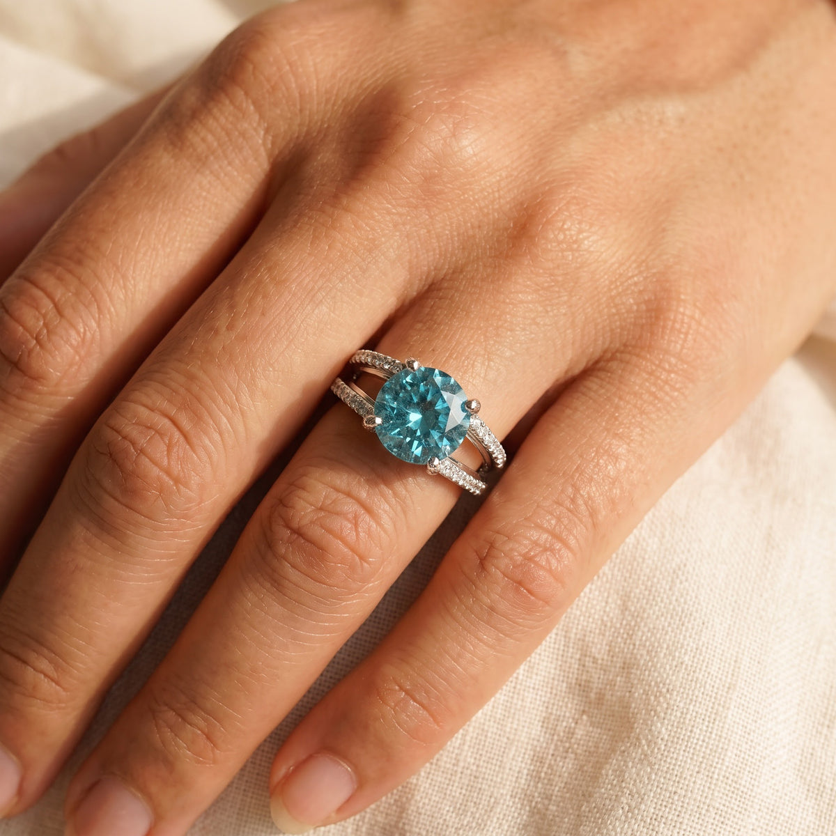 Round Blue Zircon Split Shank Ring in White Gold, worn